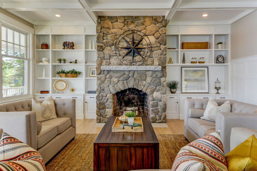 Inspiration for a large transitional formal living room in Boston with beige walls, light hardwood floors, a standard fireplace, a stone fireplace surround, no tv, beige floor, coffered and decorative wall panelling.