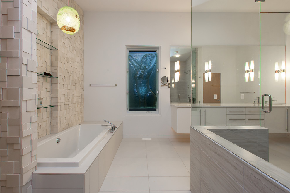 Inspiration for a contemporary bathroom in Vancouver with white cabinets and a drop-in tub.