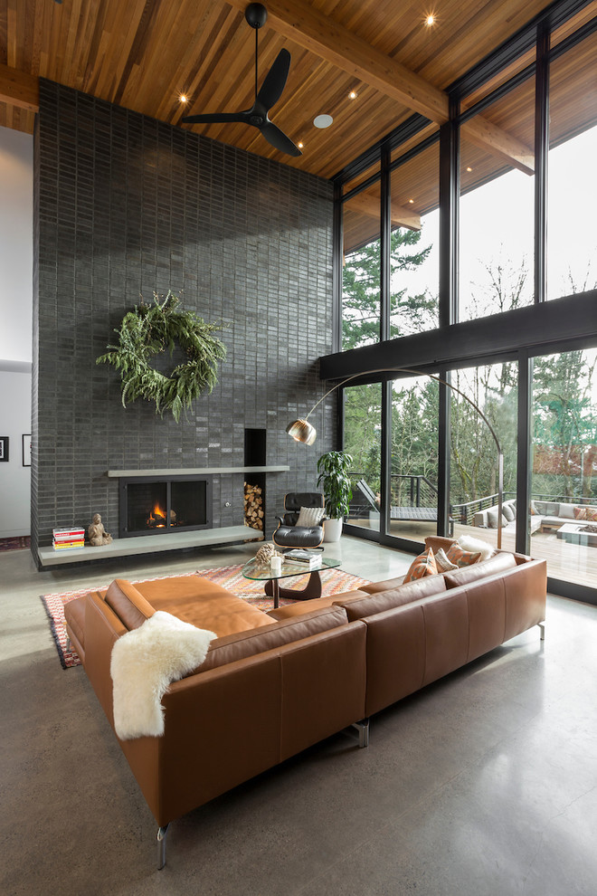 Inspiration for a large midcentury living room in Portland with white walls, concrete floors, a standard fireplace, a brick fireplace surround, no tv and grey floor.