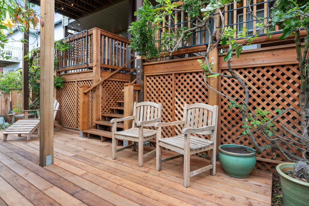 Deck - large rustic backyard ground level wood railing deck idea in San Francisco with no cover