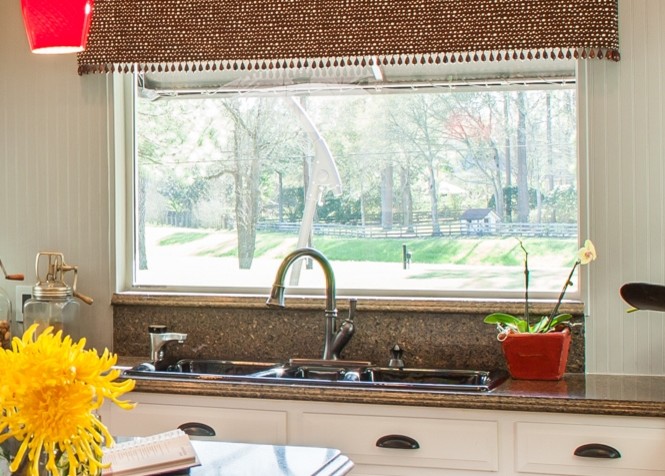 Inspiration for a large transitional u-shaped marble floor eat-in kitchen remodel in Houston with a drop-in sink, recessed-panel cabinets, white cabinets, granite countertops, brown backsplash, stone tile backsplash, black appliances and an island