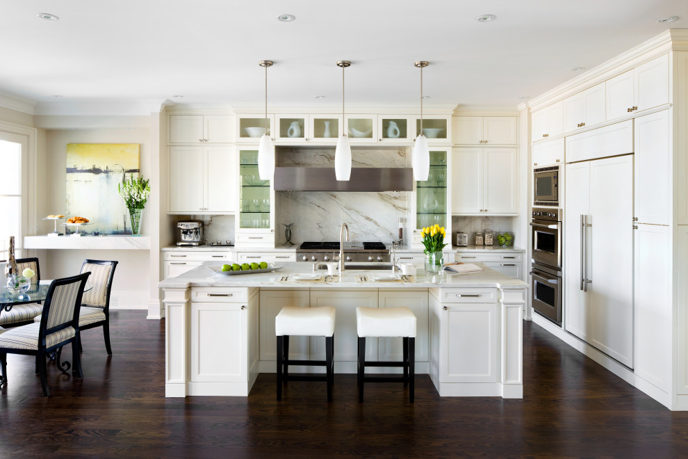 Inspiration for a mid-sized transitional l-shaped dark wood floor and brown floor kitchen remodel in Toronto with an undermount sink, shaker cabinets, white cabinets, quartz countertops, multicolored backsplash, quartz backsplash, stainless steel appliances, an island and multicolored countertops