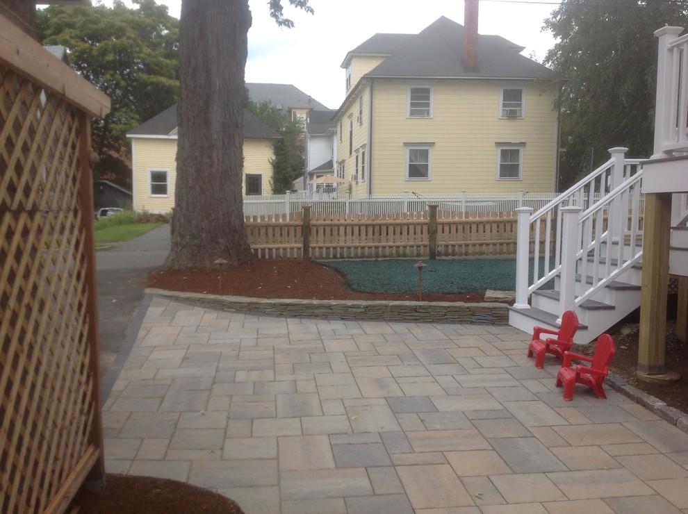 Mid-sized traditional backyard patio in Boston with concrete pavers and no cover.