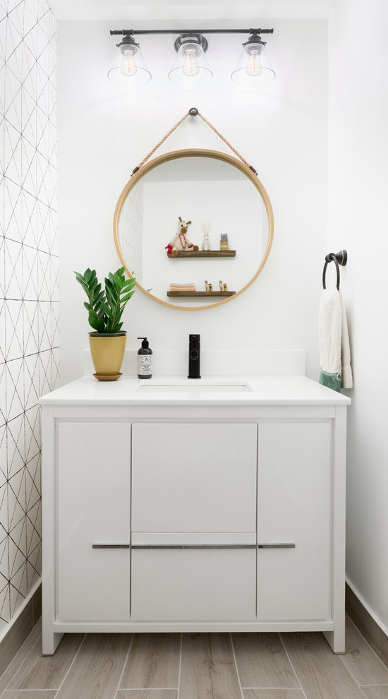 Design ideas for a small scandinavian powder room in Toronto with flat-panel cabinets, white cabinets, a one-piece toilet, white walls, porcelain floors, an undermount sink, engineered quartz benchtops, grey floor and white benchtops.