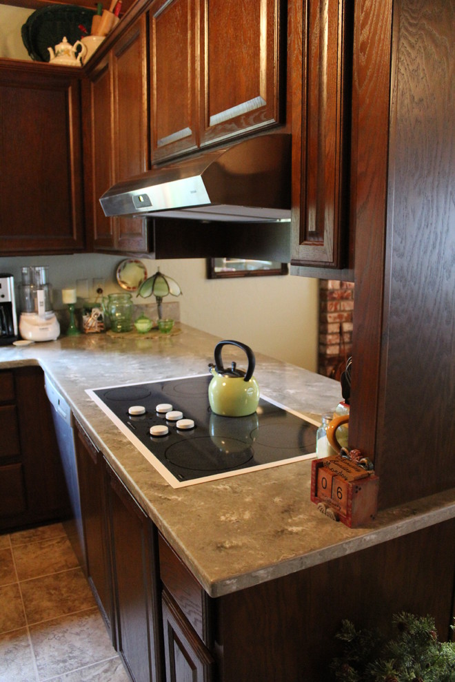 Kitchen - traditional kitchen idea with raised-panel cabinets, solid surface countertops and green backsplash