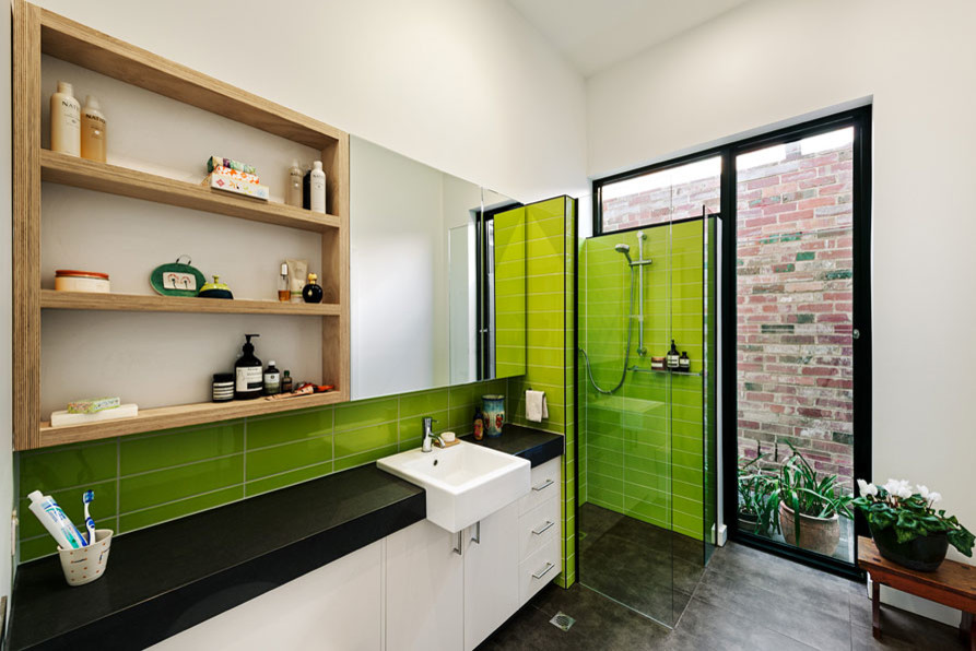 This is an example of a modern bathroom in Melbourne with green walls.