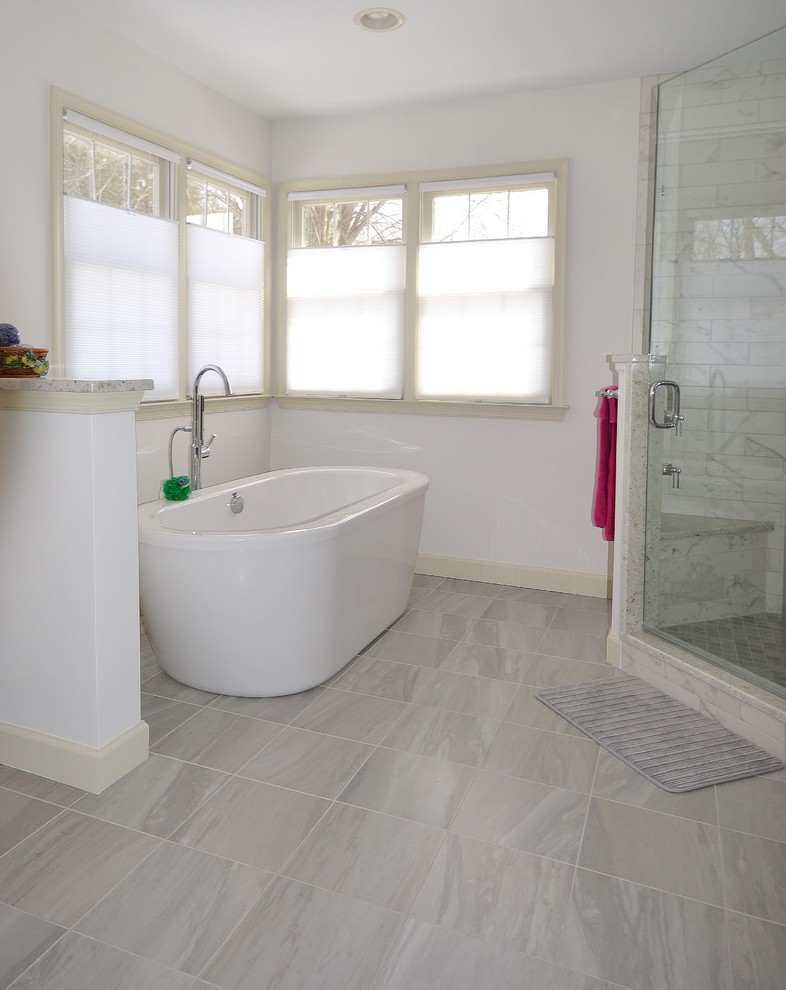Photo of a large transitional master bathroom in Philadelphia with recessed-panel cabinets, dark wood cabinets, a freestanding tub, a corner shower, a one-piece toilet, white tile, ceramic tile, white walls, ceramic floors, a drop-in sink, granite benchtops, beige floor, a hinged shower door and white benchtops.