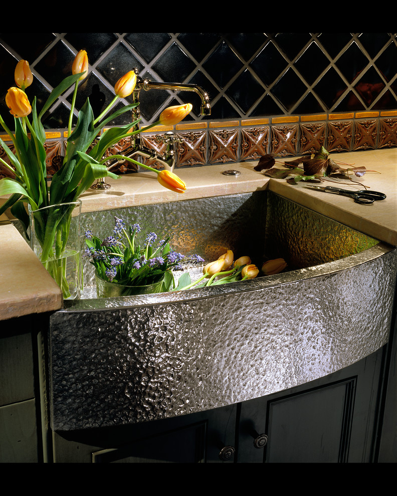 Home design - mid-sized rustic l-shaped medium tone wood floor home design idea in Chicago with a farmhouse sink, recessed-panel cabinets, green cabinets, wood countertops, multicolored backsplash, ceramic backsplash, paneled appliances and an island