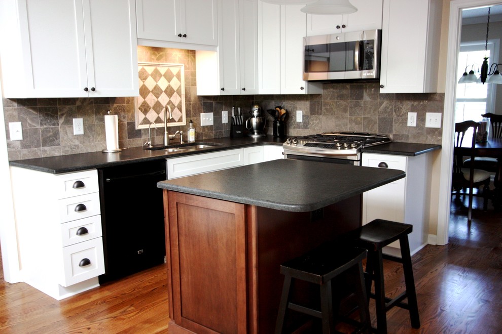 Eat-in kitchen - mid-sized transitional l-shaped medium tone wood floor eat-in kitchen idea in Raleigh with an undermount sink, shaker cabinets, white cabinets, granite countertops, gray backsplash, stone tile backsplash, stainless steel appliances and an island