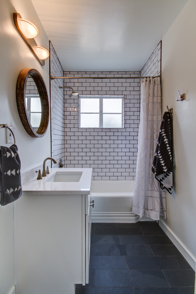 Small traditional kids bathroom in Phoenix with shaker cabinets, white cabinets, an alcove tub, a shower/bathtub combo, white tile, subway tile, grey walls, porcelain floors, an undermount sink and quartzite benchtops.