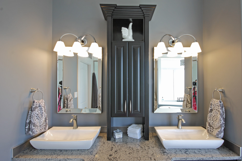 Photo of a small contemporary master bathroom in Other with a vessel sink, raised-panel cabinets, dark wood cabinets, engineered quartz benchtops, a drop-in tub, a double shower, a one-piece toilet, gray tile, grey walls, terra-cotta floors and grey floor.