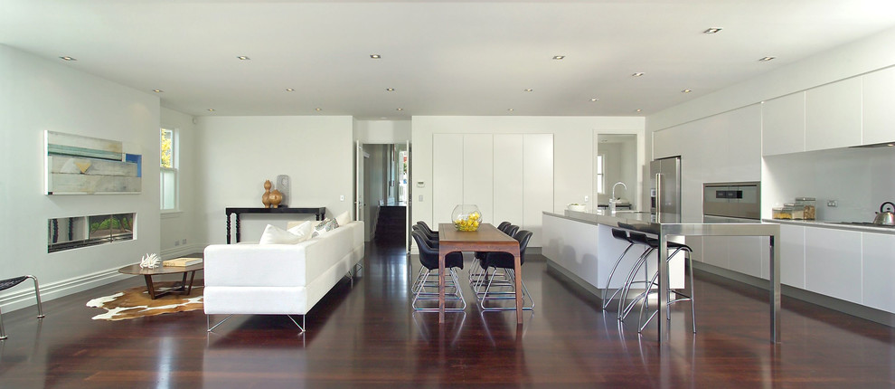 Mid-sized contemporary open concept living room in Auckland with white walls and dark hardwood floors.