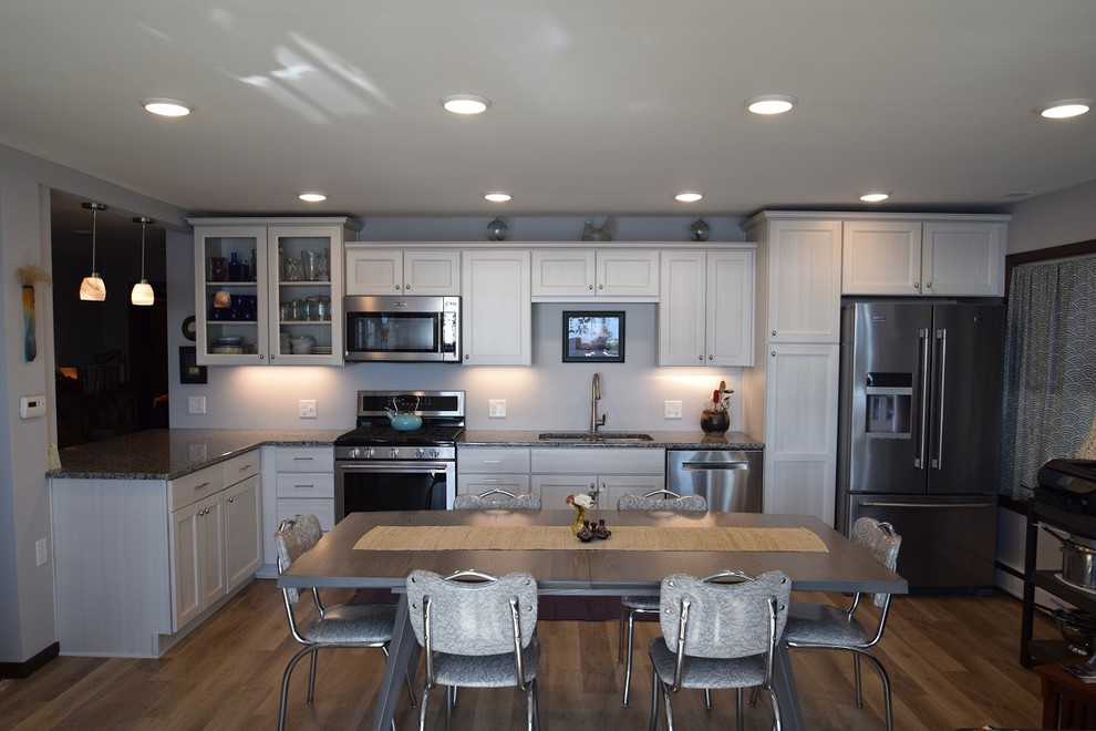 Kitchen - transitional vinyl floor kitchen idea with an undermount sink, white cabinets, granite countertops, stainless steel appliances and no island
