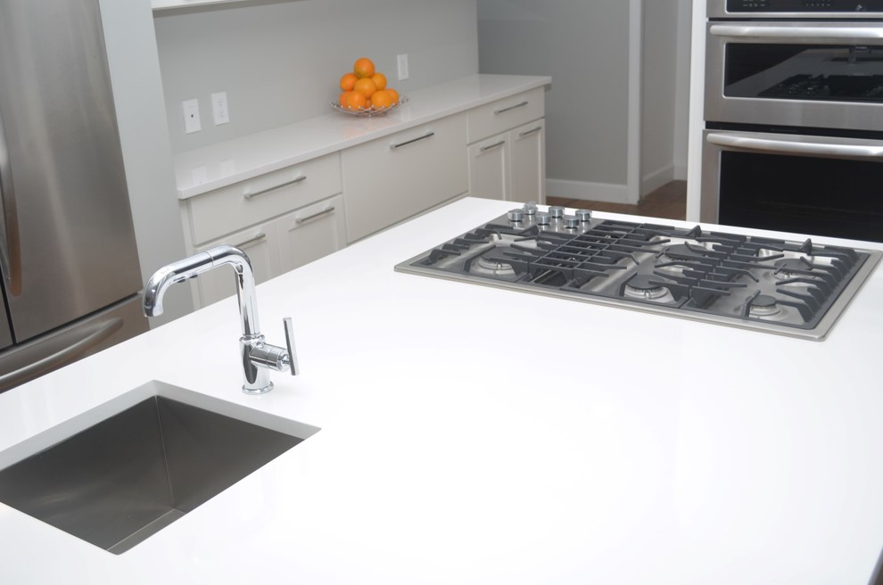 Inspiration for a large transitional medium tone wood floor eat-in kitchen remodel in Los Angeles with an undermount sink, shaker cabinets, quartz countertops, stainless steel appliances, two islands and white cabinets