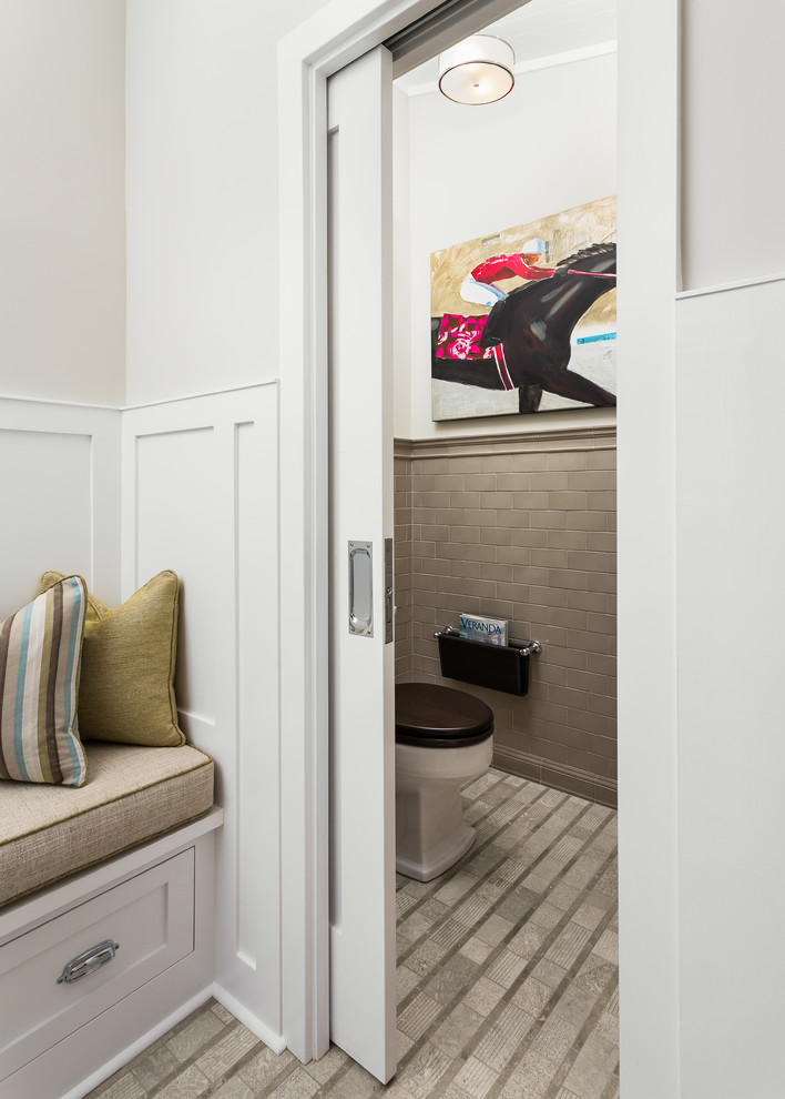 Toilet room - small transitional gray tile toilet room idea in Los Angeles with white walls