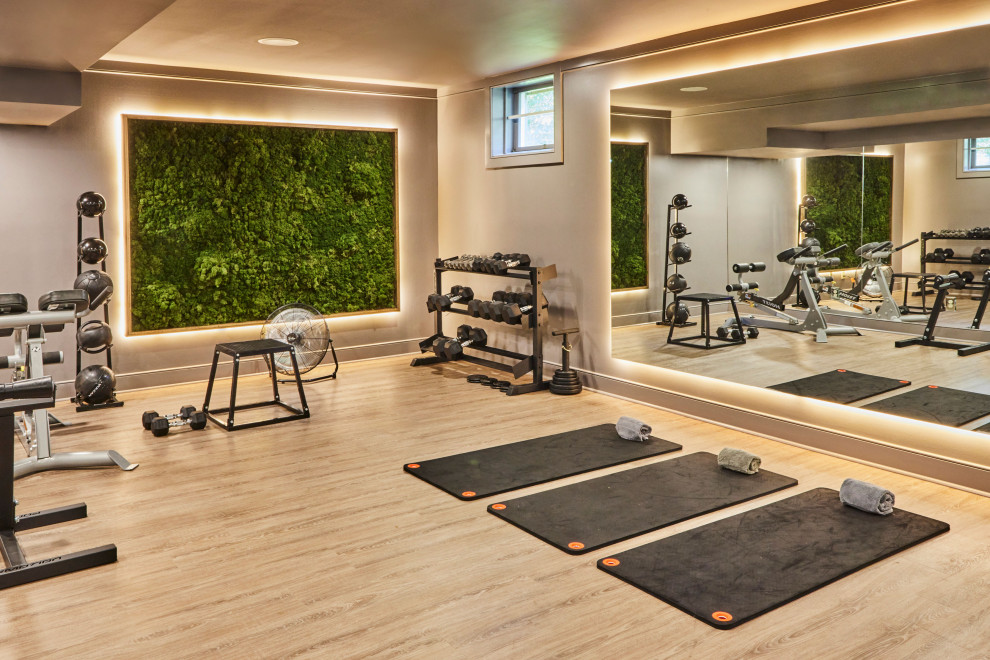 Example of a trendy light wood floor and beige floor multiuse home gym design in New York with beige walls