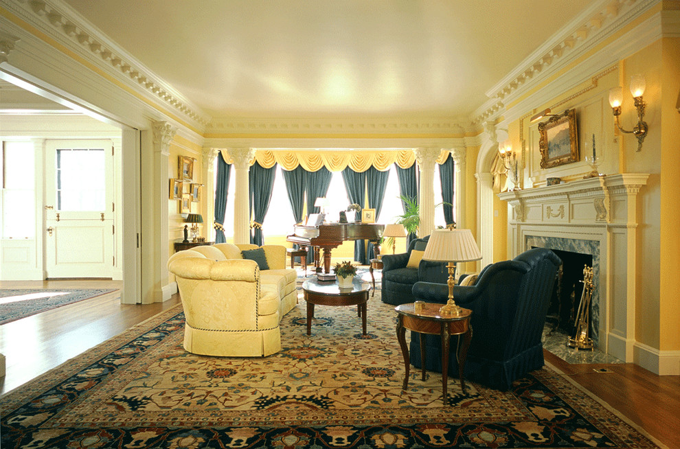 This is an example of a large traditional formal enclosed living room in Boston with medium hardwood floors, yellow walls, a standard fireplace, a stone fireplace surround and no tv.