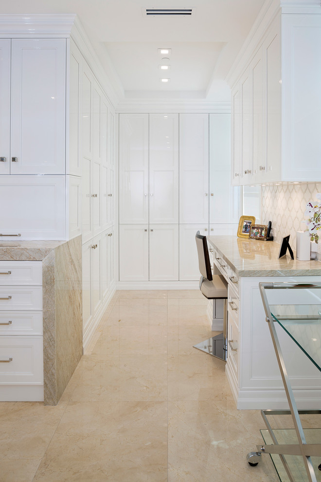 Mid-sized transitional l-shaped porcelain tile and beige floor eat-in kitchen photo in Miami with an undermount sink, recessed-panel cabinets, white cabinets, marble countertops, beige backsplash, mosaic tile backsplash, stainless steel appliances, an island and beige countertops