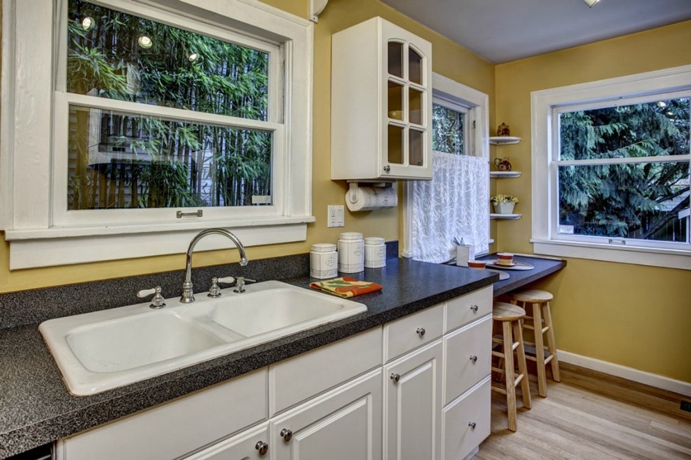Inspiration for a traditional kitchen in Seattle with a drop-in sink, raised-panel cabinets and white cabinets.