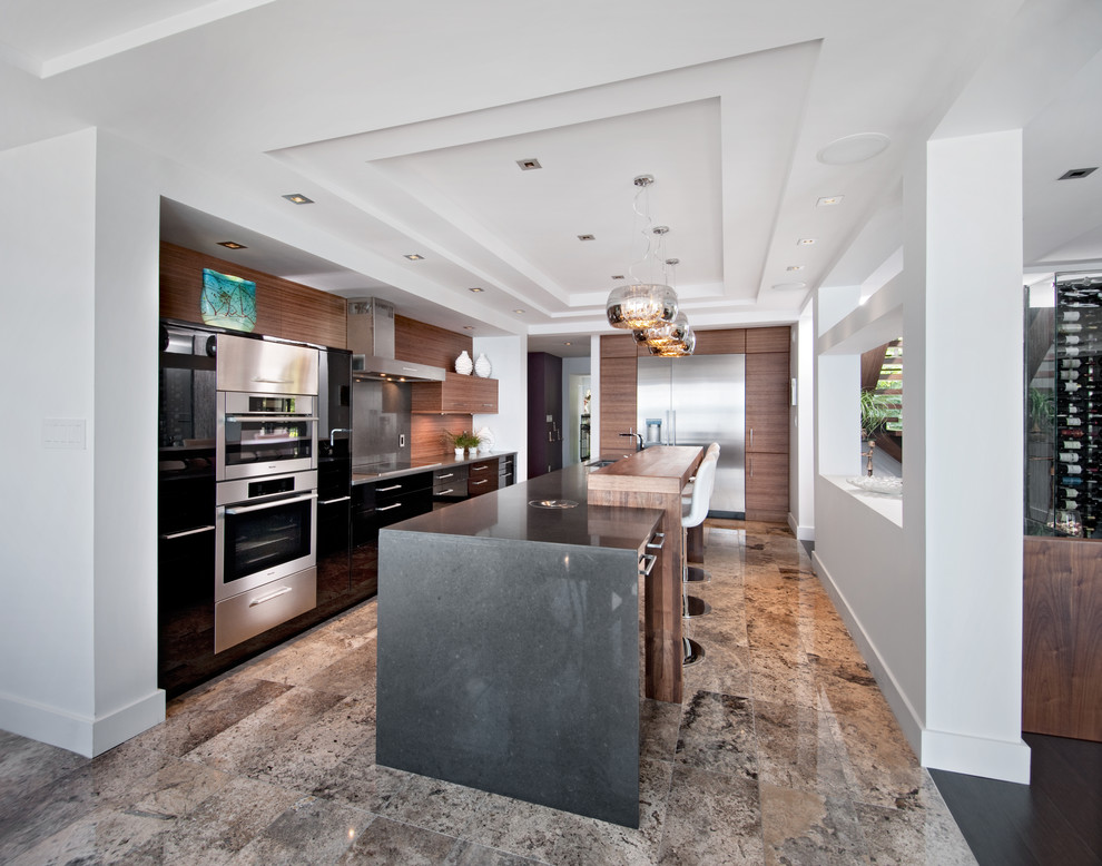 Inspiration for a large contemporary l-shaped open plan kitchen in Ottawa with stainless steel appliances, flat-panel cabinets, medium wood cabinets, brown splashback, timber splashback, limestone floors, with island and beige floor.