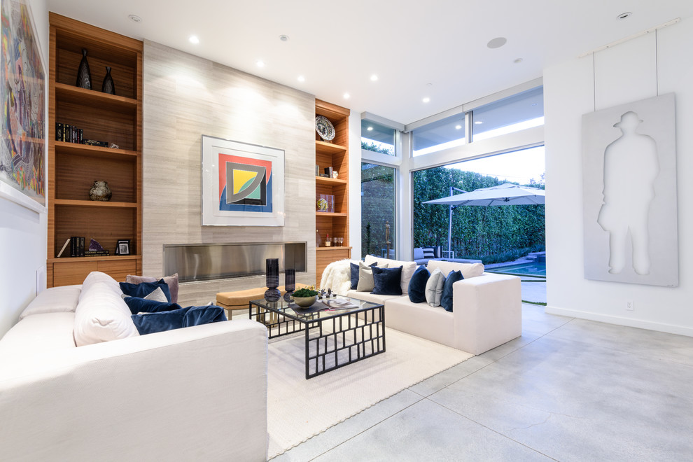 Photo of a large contemporary formal open concept living room in Los Angeles with white walls, concrete floors, a ribbon fireplace, a stone fireplace surround and grey floor.