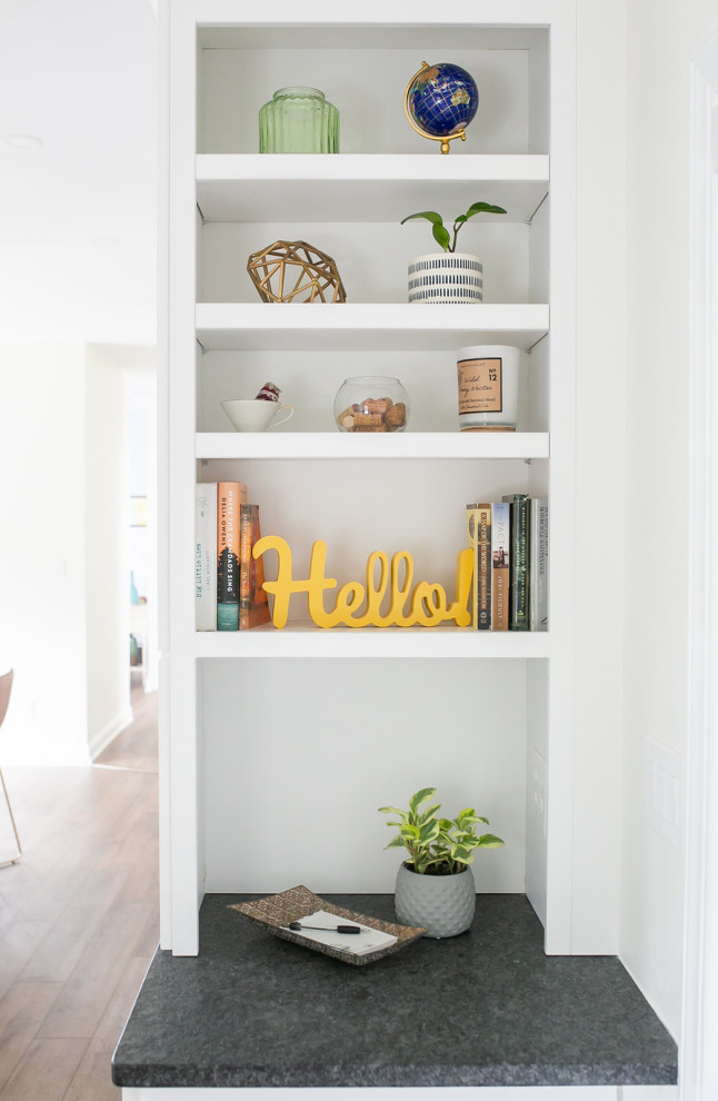 Inspiration for a large transitional l-shaped brown floor kitchen pantry remodel in Baltimore with a drop-in sink, shaker cabinets, white cabinets, quartz countertops, white backsplash, ceramic backsplash, stainless steel appliances, an island and white countertops