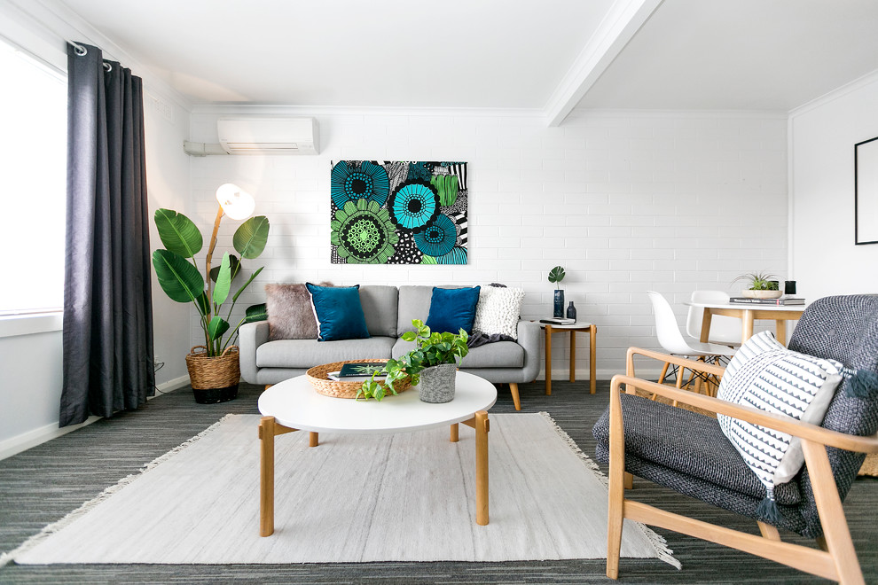 Photo of a scandinavian formal open concept living room in Hobart with white walls, carpet and grey floor.