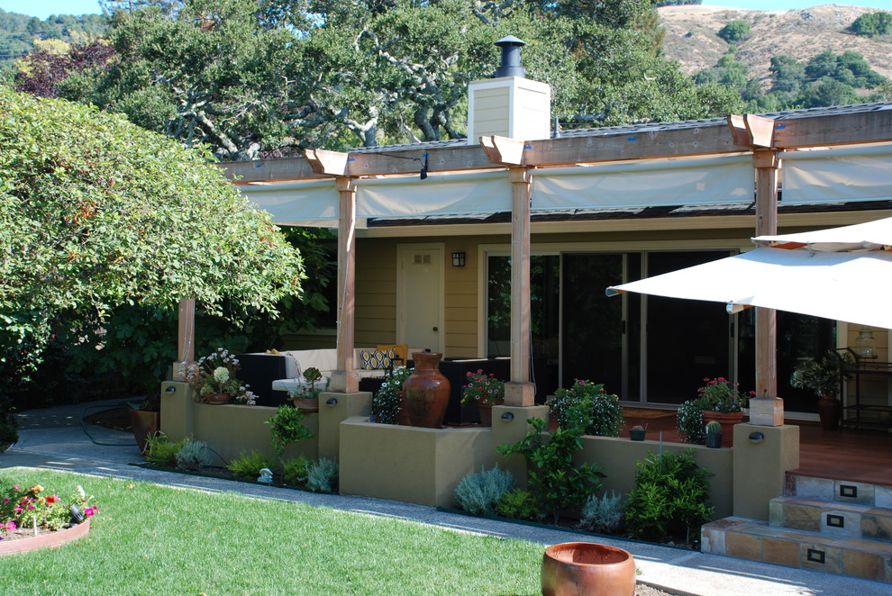 Inspiration for a large mediterranean backyard deck in San Francisco with a water feature and a pergola.