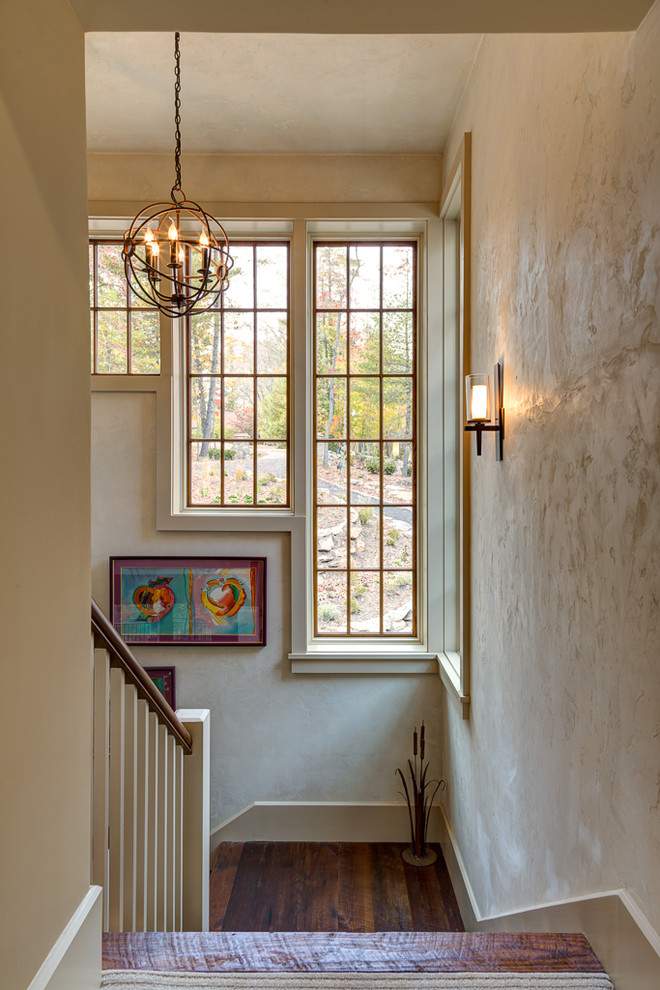 Large transitional wooden l-shaped staircase photo with wooden risers