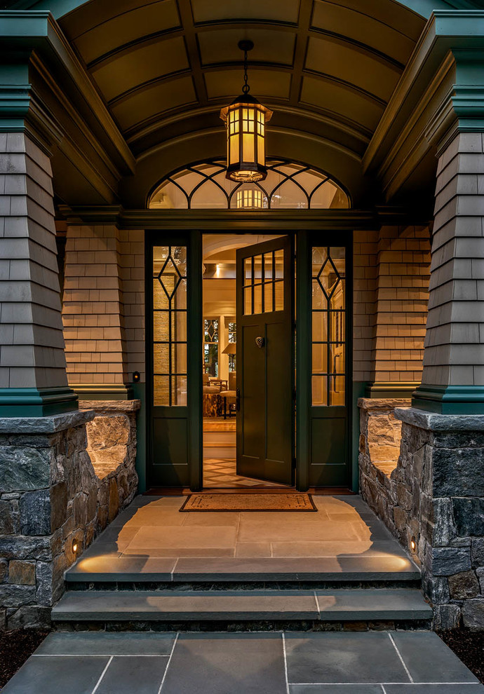 Design ideas for a traditional front door in Boston with brown walls, a single front door, a dark wood front door and grey floor.