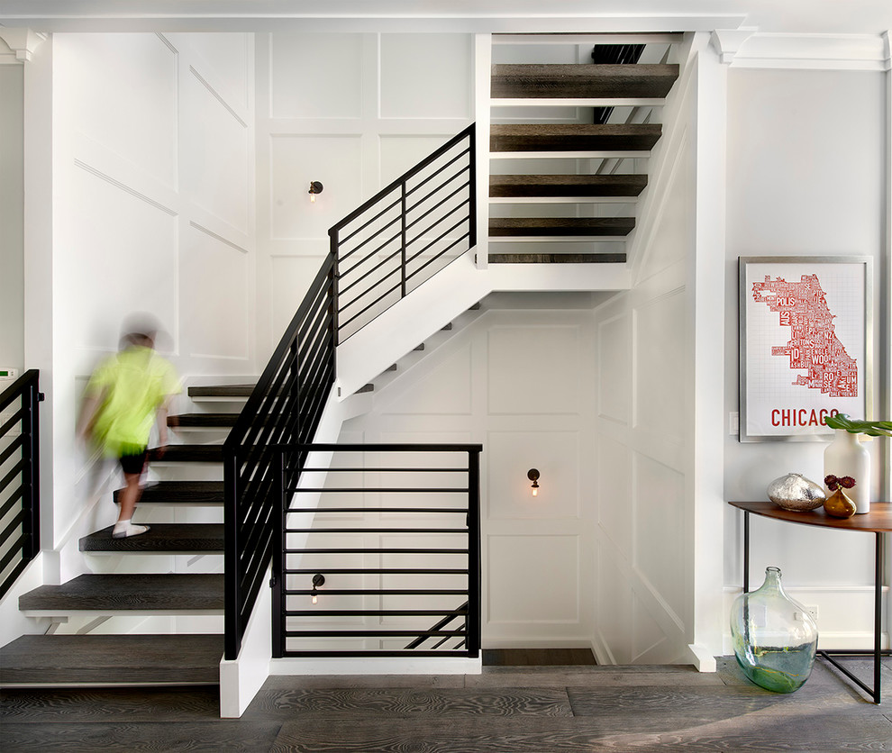Photo of a country wood u-shaped staircase in Chicago with open risers and metal railing.