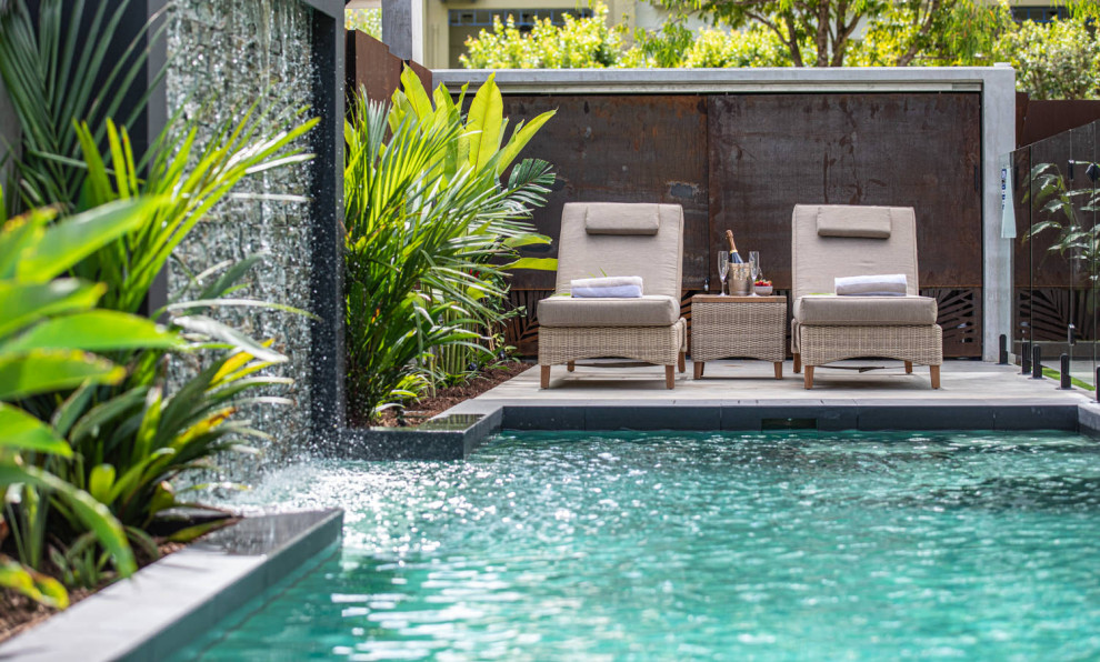 This is an example of a tropical pool in Cairns with a water feature.