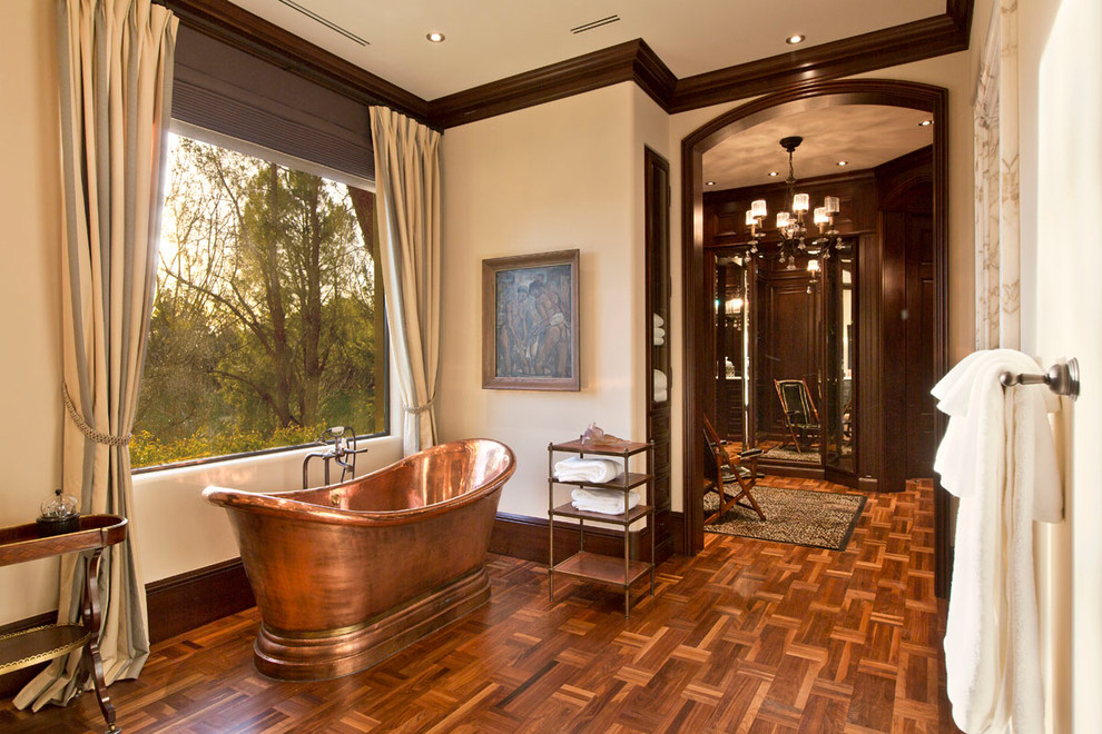 Design ideas for a mid-sized traditional master bathroom in Las Vegas with raised-panel cabinets, dark wood cabinets, an open shower, a one-piece toilet, beige walls, light hardwood floors, a drop-in sink and soapstone benchtops.