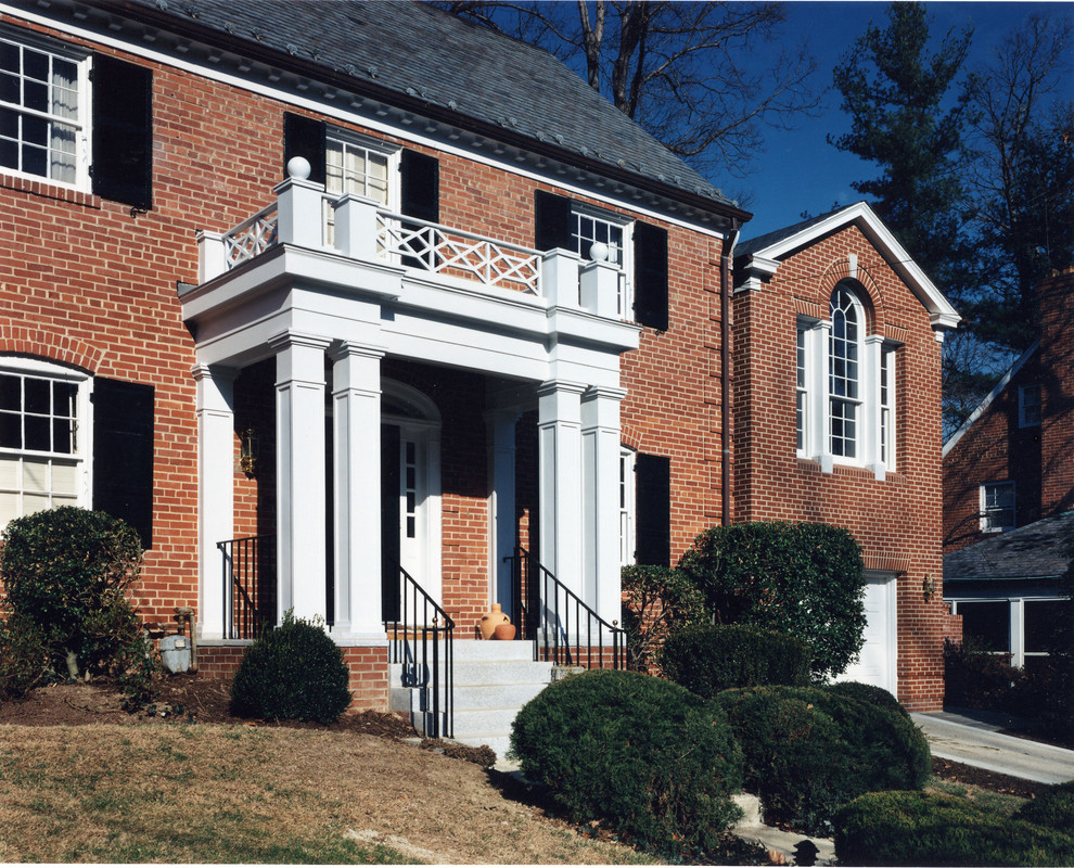 Design ideas for a mid-sized traditional front yard verandah in DC Metro with concrete slab and a roof extension.