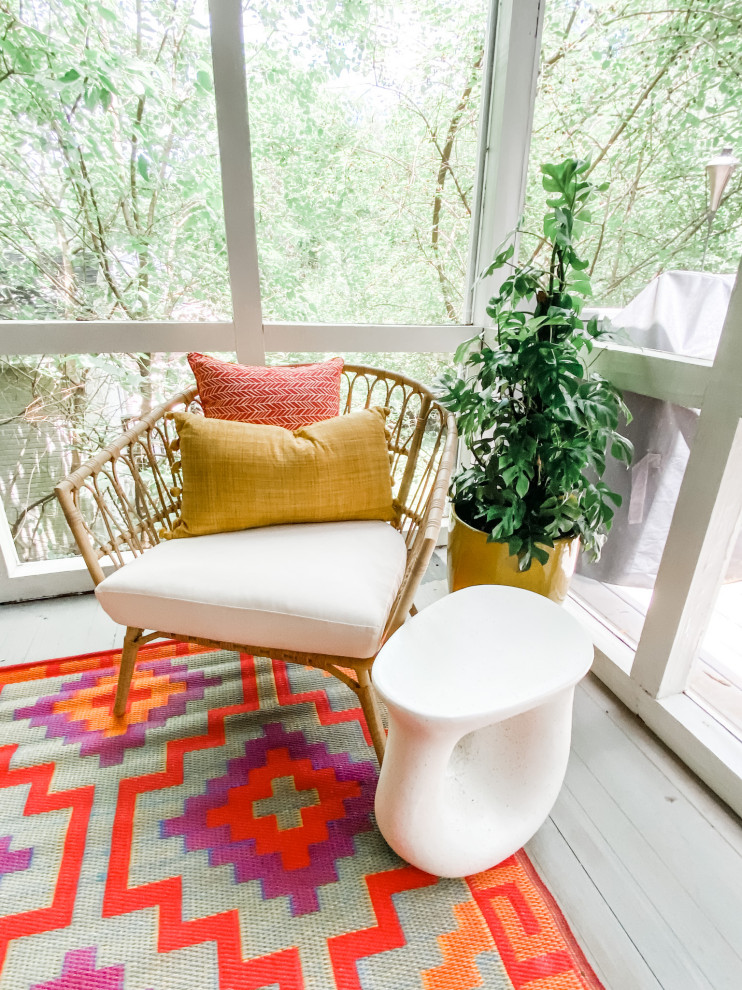 This is an example of an eclectic screened-in back porch design in Atlanta.