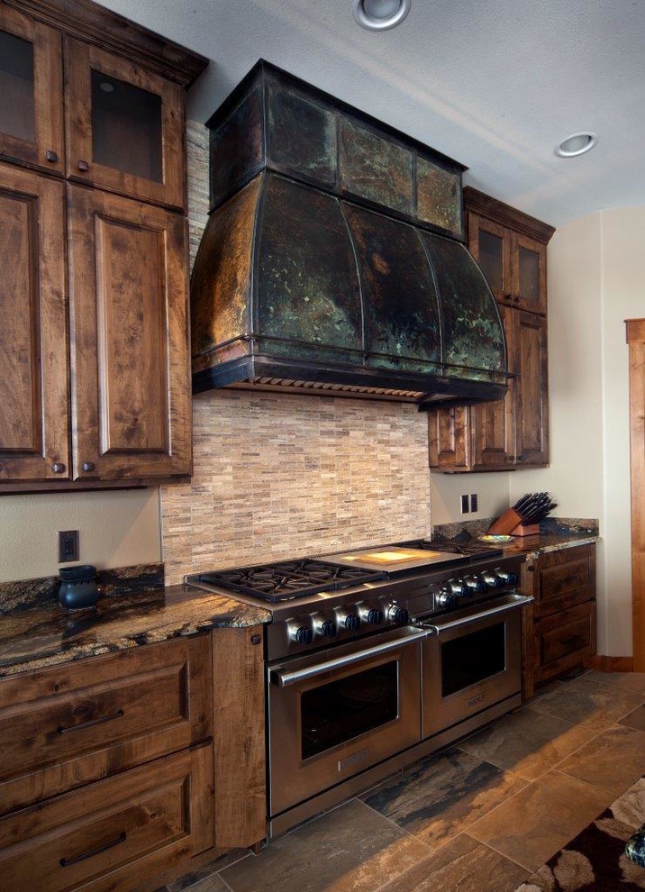 Inspiration for a rustic kitchen remodel with a farmhouse sink, raised-panel cabinets, dark wood cabinets and granite countertops
