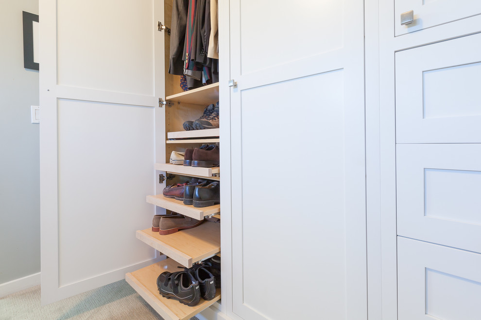 Inspiration for a large modern men's built-in wardrobe in Chicago with shaker cabinets, white cabinets, carpet and beige floor.