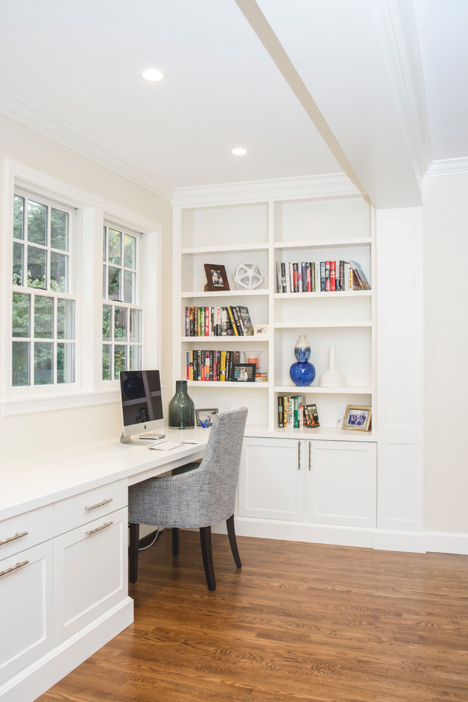 Inspiration for a large transitional home office in Boston with medium hardwood floors and beige walls.