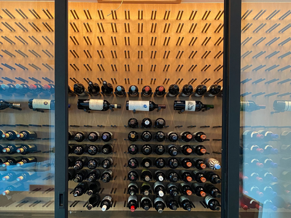Photo of a small contemporary wine cellar in Los Angeles with display racks.
