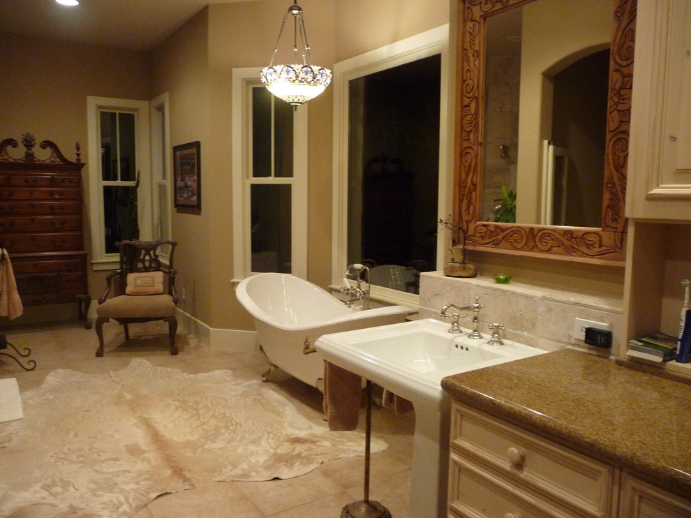 Expansive traditional bathroom in Austin with a pedestal sink, furniture-like cabinets, distressed cabinets, granite benchtops, a freestanding tub, an open shower, beige tile, stone tile, a two-piece toilet, yellow walls and porcelain floors.