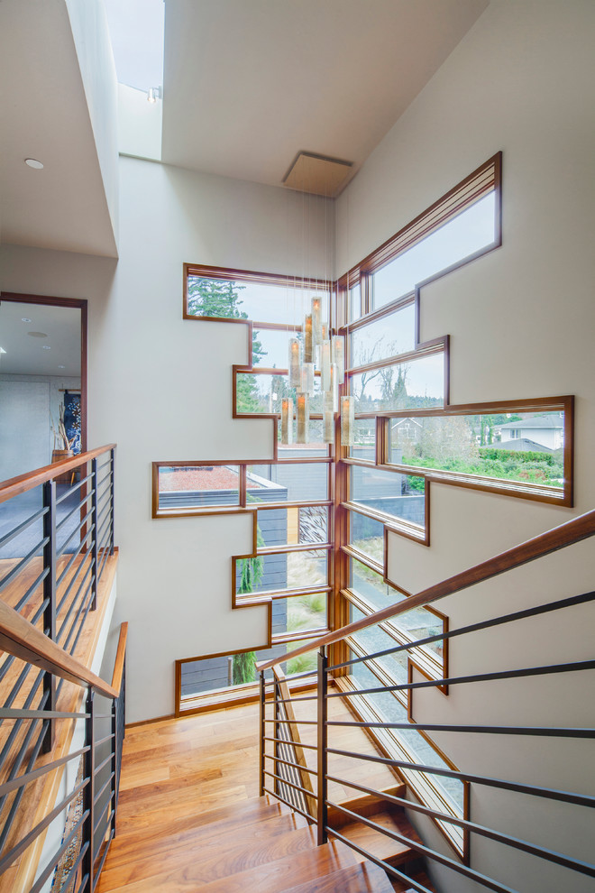 Inspiration for a mid-sized contemporary wood u-shaped staircase in Seattle with wood risers.