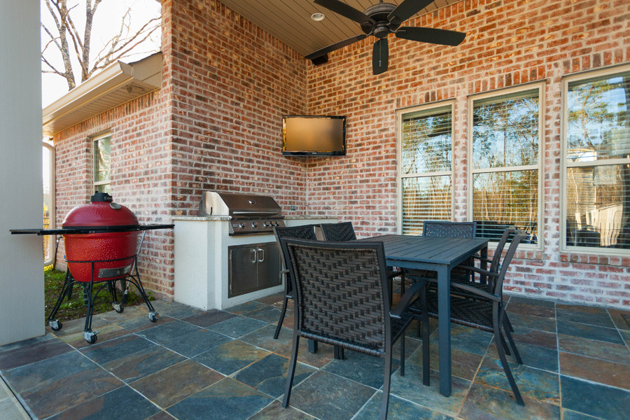 Traditional backyard patio in New Orleans with tile.