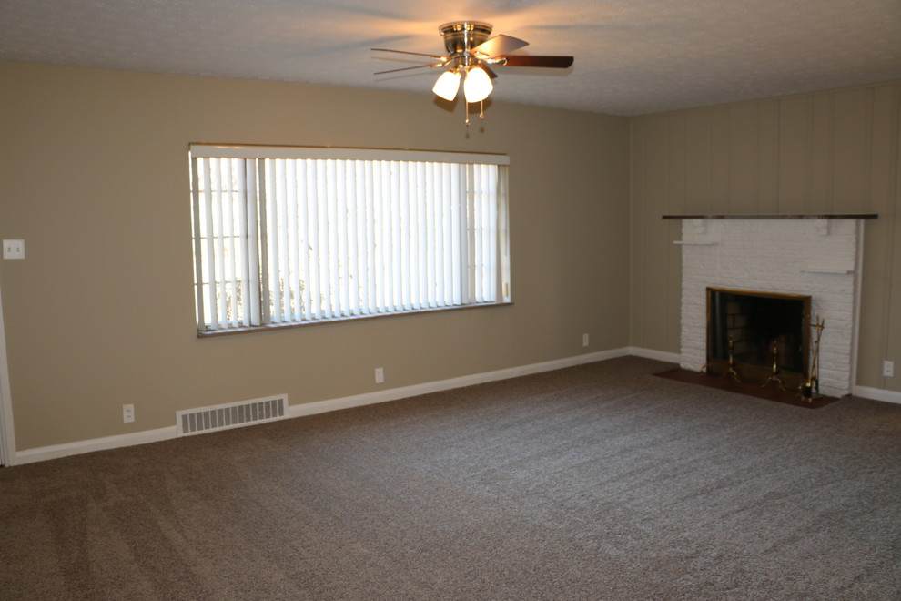 Example of a mid-sized classic open concept carpeted home design design with gray walls, a standard fireplace and a brick fireplace