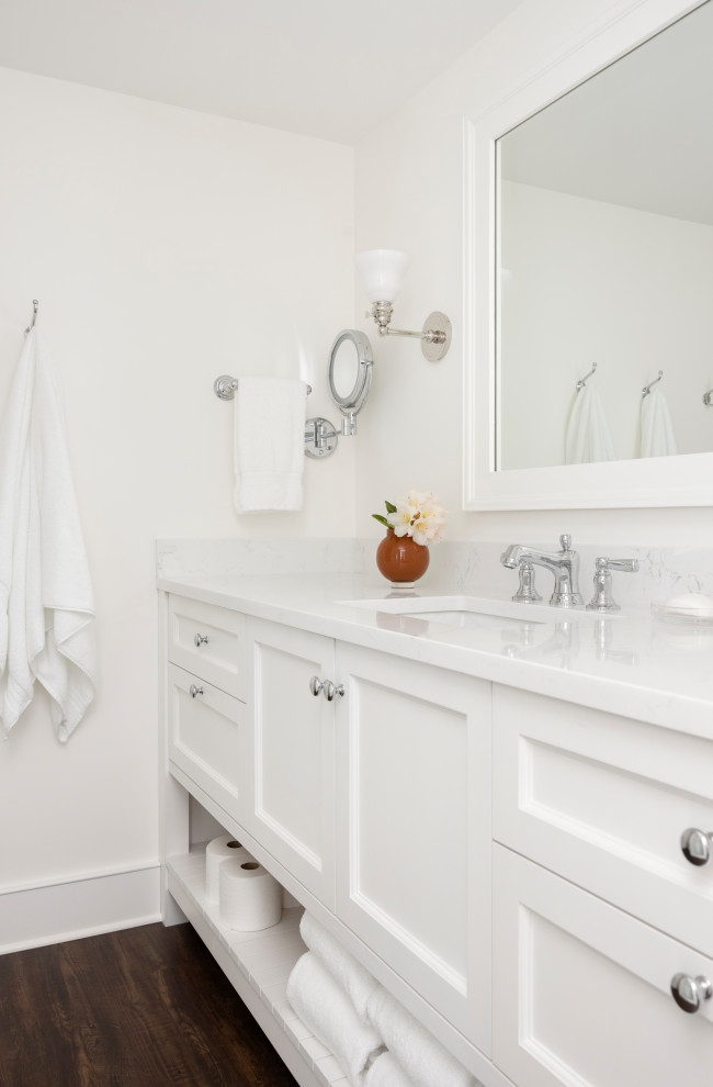 Photo of a large traditional bathroom in Portland with beaded inset cabinets, white cabinets, white tile, ceramic tile, white walls, laminate floors, engineered quartz benchtops, white benchtops, a double vanity and a built-in vanity.