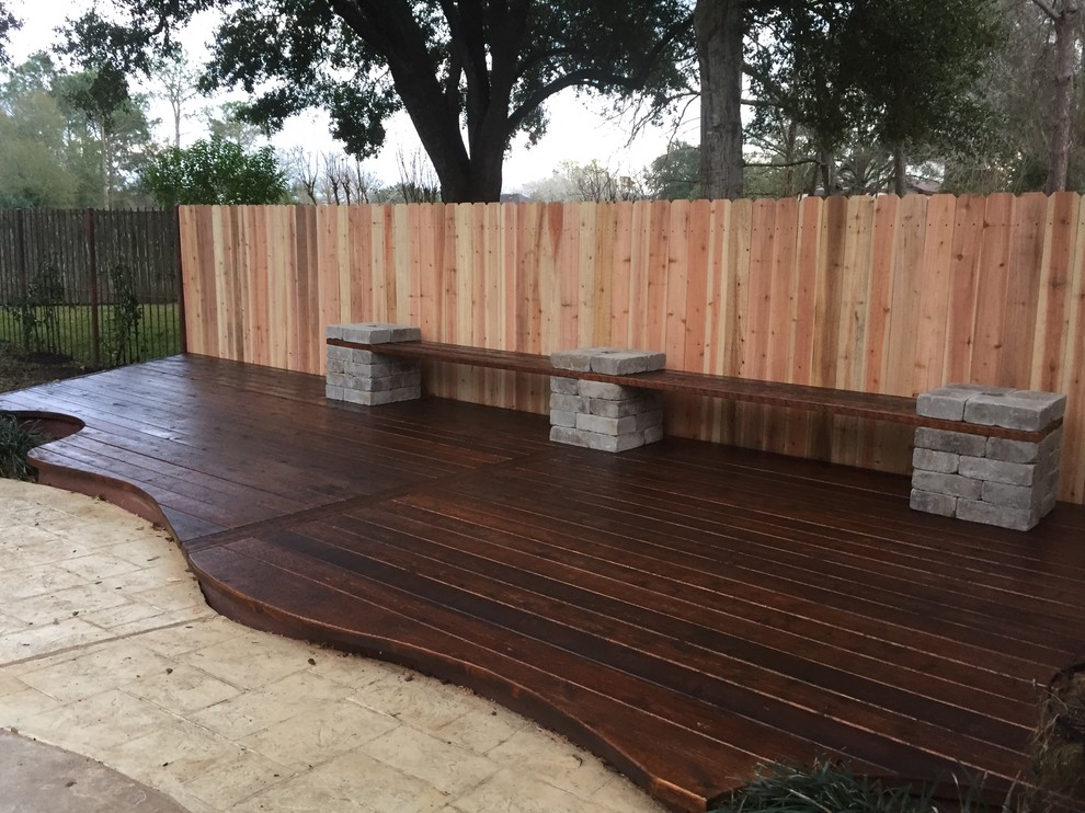 This is an example of a mid-sized traditional backyard deck in Houston with no cover.