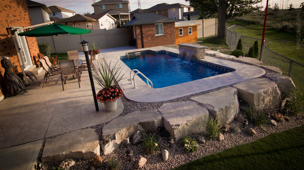 Small transitional backyard concrete and rectangular pool fountain photo in Toronto