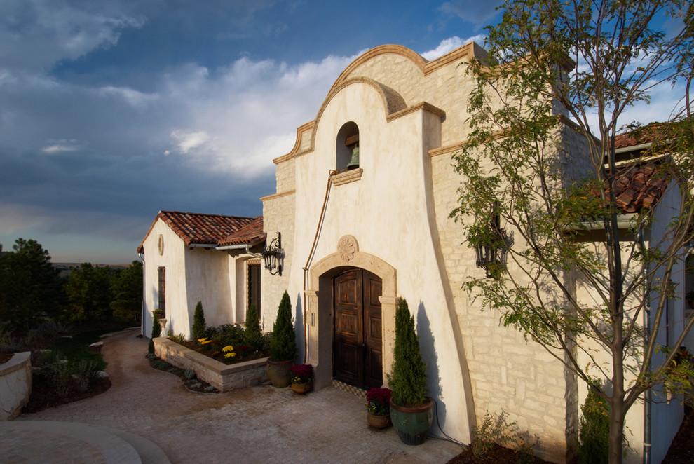 Inspiration for a mediterranean exterior in Denver with stone veneer.