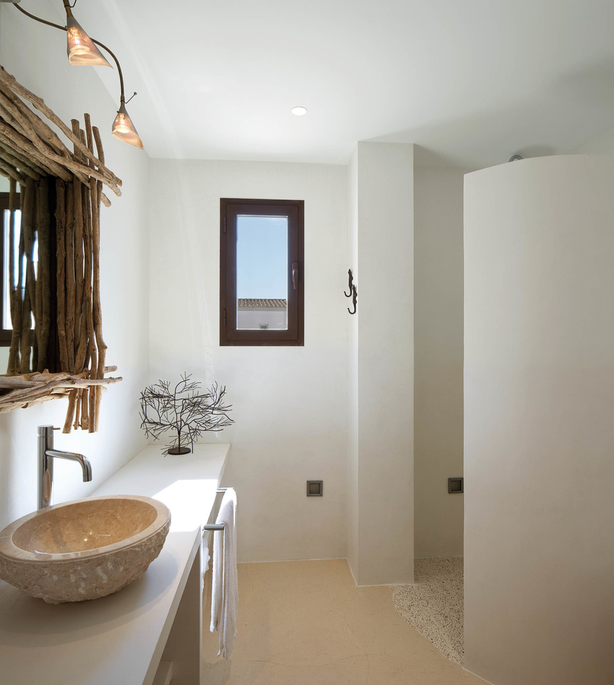Photo of a mid-sized mediterranean 3/4 bathroom in Barcelona with open cabinets, an open shower, white walls and a vessel sink.