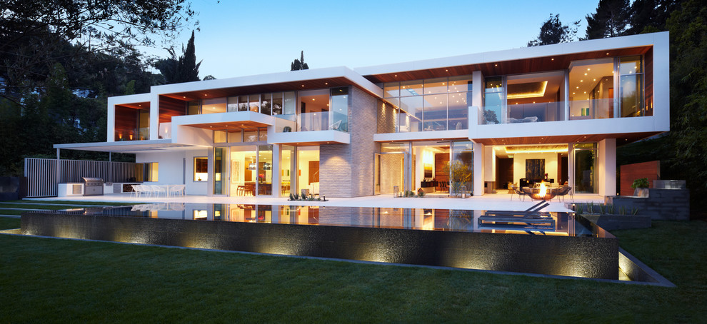 Photo of an expansive modern two-storey white exterior in Los Angeles with mixed siding and a flat roof.