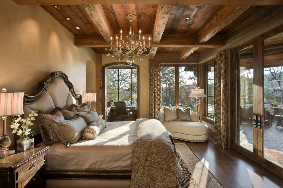 Country bedroom in Other with beige walls and dark hardwood floors.